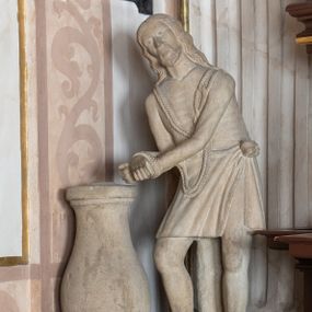 Zdjęcie nr 1: Na szerokim, ćwierćkolistym, wybrzuszonym cokole wmurowanym w północno-wschodni narożnik kaplicy ustawiona kamienna, całopostaciowa, pełnoplastyczna figura Chrystusa. Jezus stojąc zwrócony w trzech czwartych w prawo jest pochylony do przodu, z rękami skrępowanymi sznurem. Lekko przechyloną w prawo głowę charakteryzuje pociągła twarz o sumarycznie opracowanych rysach, małych oczach, prostym nosie i z krótkim zarostem. Długie, falowane włosy opadają na plecy. Nagą sylwetkę sumarycznie modelowaną w partii bioder przesłania sięgające kolan, lekko fałdowane perizonium związane na lewym boku. Krępujący  dłonie sznur w formie szerokiej pętli jest narzucony na ramiona Jezusa. 
Kolumna w kształcie pojedynczej tralki umieszczonej na czworobocznej podstawie. 
 Na cokole napis ujęty prostokątną ramką o wklęsłych narożach „PATRZ GRZESNIKU CO CIERPIĘ I NA MOIE RANY / NIE BICZUY MIE GRZECHAMI BOM DOSC SKA/TOWANY FONDATOR JAN HOŁUJ 1852”.

