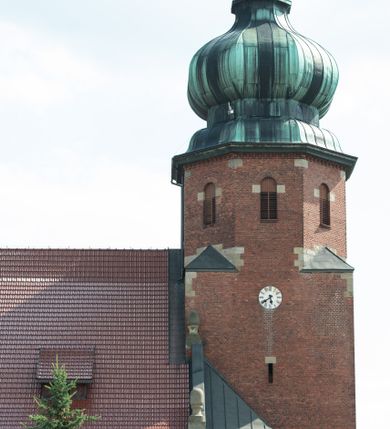 Zdjęcie nr 11: Kościół św. Jana Chrzciciela w Zembrzycach jest usytuowany na zachód od głównej drogi prowadzącej z Makowa Podhalańskiego do Wadowic i położony w centrum wsi, na placu otoczonym żeliwnym płotem na kamiennej podmurówce. Wejście na plac przykościelny prowadzi przez bramę od zachodu i wąską bramkę od północy. Kościół jest budowlą orientowaną, założoną na planie prostokąta, trójnawową, pseudohalową z prezbiterium zamkniętym trójbocznie, przy którym od północy znajduje się kaplica, a od południa piętrowa zakrystia z przedsionkiem i emporą otwartą na prezbiterium. Do nawy od strony północnej przylega wąska kruchta, nakryta dwuspadowym daszkiem. Od zachodu świątyni jest czworoboczna, masywna wieża, w górnej jednej trzeciej wysokości ośmioboczna, nakryta hełmem baniastym z latarnią. W fasadzie wysoka, półkolista wnęka z portalem i oknem termalnym. Przy wieży od północny składzik, a od południa kaplica. Ściany prezbiterium, nawy oraz elewacje aneksów w narożnikach artykułowane są szkarpami. Elewacje boczne zwieńczone ceglanym, zygzakowatym fryzem z krzyżykami. Szczyty na zakończeniach korpusu ozdobione kamiennymi szyszkami. W nawie okna trójdzielne z kamiennymi przezroczami, zamknięte łukami półkolistymi; w prezbiterium prostokątne zamknięte półkoliście. Świątynia nakryta jest dachem dwuspadowym. Na zakończeniu nawy znajduje się wieżyczka na sygnaturkę z baniastym hełmem. Wewnątrz nawy oddzielone są kolumnami z ośmiobocznymi głowicami, które wspierają sklepienia kolebkowe z lunetami. Empory i kaplice otwarte są arkadami półkolistymi. Prezbiterium podniesione jest o poziom dwóch stopni.
