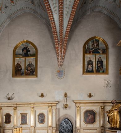 Zdjęcie nr 27: Kościół murowany z cegły, z użyciem zendrówki, na wysokim podmurowaniu z kamienia łupanego, jednonawowy, orientowany. 
Prezbiterium i nawa na planie prostokątów, nawa szersza i dłuższa od prezbiterium. Zakrystia na rzucie wydłużonego prostokąta przylega do wschodniej ściany prezbiterium, występując poza mury nawy. Prezbiterium od wschodu ujęte w narożach dwiema ukośnymi szkarpami, od południa jedną prostopadłą. Przy południowej ścianie nawy kruchta na planie kwadratu. Nawa w narożach ujęta szkarpami, od wschodu dwiema prostopadłymi, od zachodu ukośnymi. 
Prezbiterium dwuprzęsłowe, nakryte sklepieniem krzyżowo-żebrowym. Na zwornikach dwie tarcze z herbami Trzy Korony i Wieniawa. Zakrystia sklepiona kolebkowo. Nawa nakryta drewnianym stropem z kasetonami i rozetami. Kruchta sklepiona krzyżowo-żebrowo ze zwornikiem z tarczą z herbem Wieniawa. Otwór tęczowy w formie stojącego prostokąta zamkniętego łukiem ostrym. W zachodniej części nawy drewniany parapet chóru muzycznego wsparty na dwóch filarach. 
Fasada w jednej trzeciej wysokości odcięta kamiennym gzymsem kapnikowym, zakończona jodełkowym fryzem w partii muru, zwieńczona trójkątnym szczytem. Mur dekorowany zendrówką ułożoną „w zęby”, w partii szczytu w układzie rombowym. Na osi kamienny ostrołukowy portal o schodkowym nadprożu, dekorowanym krzyżującym się laskowaniem; węgary gładkie w jednej trzeciej wysokości przechodzące w piramidki i profilowanie powyżej. Nad portalem kamienna kwadratowa tablica, ujęta kamiennym obramieniem z tarczą z herbem Wieniawa. Ponad nią, na osi okulus w kamiennym obramieniu. 
Elewacje północna i południowa w części nawy w jednej trzeciej wysokości przedzielone kamiennym gzymsem kapnikowym, na zakończeniu ścian z gzymsem wieńczącym. Mur dekorowany zendrówką w układzie rombowym. Na elewacji południowej cztery okna w formie wydłużonego, stojącego prostokąta zamkniętego łukiem ostrym, w kamiennych obramieniach, podzielone laskowaniem. Południowa ściana prezbiterium zakończona gzymsem wieńczącym, w górnej części muru dekorowana zendrówką ułożoną „w zęby”. 
Szkarpy opinające nawę uskokowe, zwężające się ku górze, nakryte daszkami pulpitowymi. Szkarpy opinające prezbiterium nakryte daszkami pulpitowymi, podzielone gzymsami kapnikowymi. 
Kruchta od strony wschodniej i zachodniej podzielona kamiennym gzymsem kapnikowym, od południa zakończona gzymsem wieńczącym. Na ścianie południowej kruchty kamienny, ostrołukowy portal, o schodkowym nadprożu, dekorowanym krzyżującym się laskowaniem; węgary gładkie, w jednej trzeciej wysokości przechodzące w piramidki i profilowanie powyżej. Nad portalem kamienna tarcza z herbem Wieniawa. 
Elewacja wschodnia zwieńczona trójkątnym szczytem, w którego partii mur dekorowany jest zendrówką w układzie rombowym. Na osi okno w formie wydłużonego, stojącego prostokąta zamkniętego łukiem ostrym, w kamiennym obramieniu, zamurowane w trzech piątych wysokości, zakończone daszkiem pulpitowym. W dolnej części okna znajduje się ogrójec. 
Nawa i prezbiterium nakryte osobnymi blaszanymi dachami dwuspadowymi, kruchta i zakrystia pulpitowymi. Nad nawą blaszana wieżyczka na sygnaturkę z latarnią i hełmem baniastym.





