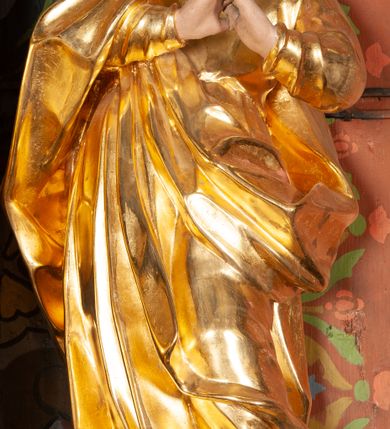 Zdjęcie nr 17: Ołtarz przyścienny, architektoniczny, jednoosiowy, jednokondygnacyjny ze zwieńczeniem. Mensa prostopadłościenna na niskim cokole. Nastawa ołtarzowa ustawiona na wysokim dwustrefowym cokole. Retabulum ujęte parą kolumn o stylizowanych, jońskich głowicach. Podpory wspierają belkowanie o wklęsłym wykroju, przerwane w części środkowej. Na gzymsie odcinki przyczółka o wolutowo skręconych końcach, skierowanych do wewnątrz. Zwieńczenie o wklęsłych bokach, zamknięte, dwoma stykającymi się wolutami z glorią promienistą. Pośrodku glorii symbol Opatrzności Bożej z IHS. Pole środkowe w formie prostokątnej wnęki ujętej ornamentem rocaille’owym. We wnęce rzeźbiony krucyfiks, zawieszony na tle malowanego pejzażu. Po bokach ołtarza, na osobnych konsolach ustawione figury Matki Boskiej po lewej oraz św. Jana Ewangelisty po prawej stronie. Po bokach zwieńczenia, na belkowaniu dwie pary rzeźbionych, uskrzydlonych aniołków. Boki wnęki środkowej dekorowane ornamentem rocaille’owym. Fontowe ścianki cokołów zdobione ażurowymi, wolutowo zwiniętymi liśćmi akantu. W zwieńczeniu obraz z przedstawieniem św. Michała Archanioła ujęty ramą formowaną z motywów „C” kształtnych. Struktura ołtarza malowana w kolorze niebieskim, boki mensy z prostokątnymi jasnobrązowymi płycinami, detal architektoniczny i profilowania złocone.

Figury uskrzydlonych aniołów pełnoplastyczne, ścięte z tyłu, siedzące na obłokach powyżej belkowania retabulum. Anioł po prawej stronie o szeroko rozłożonych rękach, głowie przechylonej w prawą stronę (h.). Anioł po lewej z rękoma uniesionymi, skierowanymi w prawo, głowa lekko pochylona, zwrócona w lewo. Figury niemal nagie, ze złotą przepaską wokół bioder. Twarze owalne o wydatnym czole okolone jasnobrązowymi włosami. Karnacja ciała w jasnokremowym odcieniu.