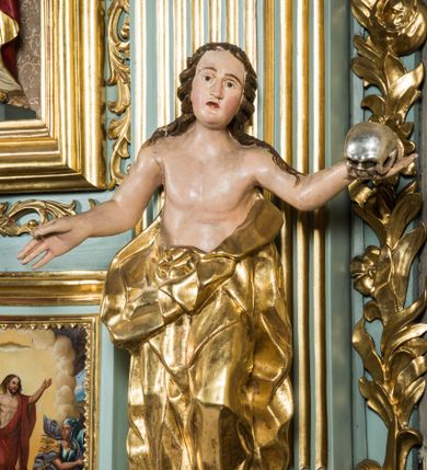 Zdjęcie nr 1: Pełnopostaciowa figura ukazuje stojącą frontalnie świętą Marię Magdalenę w kontrapoście. Święta rozkłada ręce, trzymając w lewej dłoni srebrzoną czaszkę. Kobieta ma pociągłą twarz o pucułowatych, rumianych policzkach, wyrazisty nos i usta oraz szeroko otwarte oczy ze spojrzeniem skierowanym na widza. Jej głowę otaczają długie brązowe włosy spływające na ramiona. Ubrana jest w złoconą, mocno drapowaną suknie ściągniętą do pasa, odsłaniającą jej nagi tułów i ręce. Spod szaty widać końce bosych stóp.