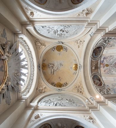 Zdjęcie nr 37: Kościół jest murowany z cegły, z użyciem ciosu kamiennego w partii cokołu i jako okładziny, tynkowany, z kryptami odpowiadającymi rzutowi. Założony jest na rzucie krzyża łacińskiego, z czteroprzęsłową nawą ujętą kaplicami, trójprzęsłowym prezbiterium zamknięty prosto, półtoraprzęsłowymi ramionami nawy poprzecznej, wysuniętymi poza korpus, zamknięte prosto i z kopułą na skrzyżowaniu naw. Przęsło fasady jest ujęte dwiema lokalnościami i dwiema wysuniętymi poza obręb korpusu wieżami z okrągłymi klatkami schodowymi z drewnianymi kręconymi schodami prowadzącymi do pomieszczeń nad lokalnościami. Do prezbiterium przylegają od południowego wschodu zakrystia, od północnego zachodu skarbiec, z składzikami na piętrze. 
Nawa jest artykułowa za pomocą pilastrów kompozytowych, zdwojonych w prezbiterium, transepcie i nawie głównej, zwielokrotniony w krzyżu kościoła, dźwigających wydatne belkowanie. Ściany kaplic są artykułowane za pomocą płytkich, opilastrowanych arkad; mury tarczowe kaplic wydzielone za pomocą gzymsu przełamującego się w narożnikach. Nawa i prezbiterium są sklepione kolebkami na gurtach z lunetami, transept sklepieniem kolebkowym na gurtach, kaplice pseudokopułami na pendentywach (w kaplicy Matki Boskiej i św. Katarzyny kopuły na rzucie elipsy z latarniami), zakrystia i skarbiec sklepieniem krzyżowo-kolebkowo, a przedsionki – nieckowym z lustrem. Okna nawy głównej i prezbiterium w profilowanych obramieniach, prostokątne, zamknięte łukiem segmentowym, okna kaplic są półkoliste. Bęben kopuły rozczłonkowany parami pilastrów kompozytowych, a między nimi rozlokowane naprzemian półkoliście zamknięte nisze i prostokątne okna. Do kościoła prowadzą drzwi wejściowe i para drzwi bocznych, z prezbiterium drzwi wejściowe do skarbca i zakrystii, z zakrystii na dziedziniec przy kościele. 
Fasada poprzedzona schodami, dwukondygnacyjna, dwuwieżowa, w dolnej kondygnacji siedmioosiowa, w górnej trójosiowa z dwiema wyodrębnionymi wieżami. Dolna kondygnacja rozczłonkowana zwojonymi pilastrami i parami kolumn flankujących oś środkową, o kapitelach kompozytowych, podtrzymujących wyłamujące się nad nimi belkowanie z wydatnym gzymsem i attyką, ponad belkowaniem w osi środkowej przerwany przyczółek. Górną kondygnację ujmują pary pilastrów ze stojącymi na ich tle wazonami, dźwigające wyłamujące się nad nimi belkowanie, w części środkowej zwieńczone przyczółkiem, w wieżach – miedzianymi hełmami. 
W części środkowej dolnej kondygnacji znajduje się zamknięta półkoliście wnęka z portalem, ujętym ukośnie dostawionymi pilastrami z konsolami podtrzymującymi naczółki i z tablicą z wklęsłymi bokami, zwieńczoną gzymsem w kształcie łuku nadwieszonego; ponad tablicą znajduje się półkoliste okno. Nad drzwiami bocznymi płaskorzeźbione postacie klęczących aniołów i kwadratowe okna, w wieżach wnęki z figurami św. Bernarda (po lewej) i św. Jana Kantego (po prawej). W części środkowej drugiej kondygnacji umieszczone jest prostokątne okno zamknięte łukiem segmentowym i zwieńczone przerwanym przyczółkiem. W polach bocznych nisze z figurami św. Kazimierza (po lewej) i św. Floriana (po prawej). Ściany boczne wzmocnione szkarpami, podzielone lizenami i pilastrami toskańskimi w dolnej kondygnacji prezbiterium oraz południowo wschodniej i północno zachodniej ścianie transeptu. Prezbiterium i ramiona transeptu zamknięte trójkątnymi szczytami z owalnymi oknami. Tambur kopuły rozczłonkowany lizenami, z oknami zamkniętymi łukami segmentowymi, w profilowanych obramieniach; ośmiopolową kopułę krytą blachą wieńczy latarnia opięta półkolumnami, pomiędzy którymi znajdują się wąskie okna zamknięte półkoliście. Nawę, prezbiterium i transept nakrywa dach siodłowy, nad pozostałymi pomieszczeniami dachy siodłowe, z wyjątkiem środkowych kaplic, w których kopułki wtopione zostały w dach i zwieńczone latarniami.  
