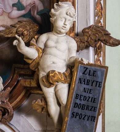 Zdjęcie nr 3: Ołtarz architektoniczny, jednokondygnacyjny, jednoosiowy, ze zwieńczeniem. Ołtarz prostopadłościenny, murowany. Retabulum o strukturze wklęsłej wzdłuż osi pionowej osadzone na niewysokim, cokole zryzalitowanym w formie pary impostów. Gzyms cokołu pośrodku ma formę półkolistego łuku nadwieszonego. Część środkowa ujęta parą wąskich filarów, licami zwróconych ukośnie na zewnątrz, wspierających wydatny gzyms osadzony na parze spływów wolutowych. Pola cokołu retabulum zdobione ornamentyką roślinną. Na impostach para figur aniołków, stojący po lewej stronie w lewej dłoni ma zwój z napisem „PATRZ / SWEGO / A NIE / PRAGNIJ / CUDZEGO”, stojący po prawej trzyma lewą ręką wspartą na podłożu tarczę z napisem „ZLE / NABYTE / NIE / BĘDZIE / DOBRZE / SPOŻYTE”. Między impostami płycina w kształcie prostokąta leżącego o wklęsłych górnych narożach i zamkniętego półkolistym łukiem nadwieszonym. W dolnej partii retabulum para uskrzydlonych główek anielskich dołem ujętych liśćmi akantu. Lica filarów zdobione motywem kampanuli. W partii belkowania, pośrodku motyw akantowego kartusza z napisem „VENI / CORONABE/RIS.”, ujętego górą, dołem i po bokach motywami uskrzydlonych główek anielskich. Zwieńczenie w formie promienistej glorii z koroną osadzoną na obłokach. Całość flankuje para siedzących na gzymsie aniołów w dynamicznych pozach. Pole części środkowej w kształcie stojącego prostokąta ujętego górą i dołem parą zwróconych do siebie półkolistych łuków nadwieszonych z uskokami, ujęte profilowaną, złoconą ramą. Wewnątrz obraz z wizerunkiem Matki Boskiej. Struktura polichromowana w kolorze białym, detal architektoniczny i ornamentyka złocone i srebrzone.