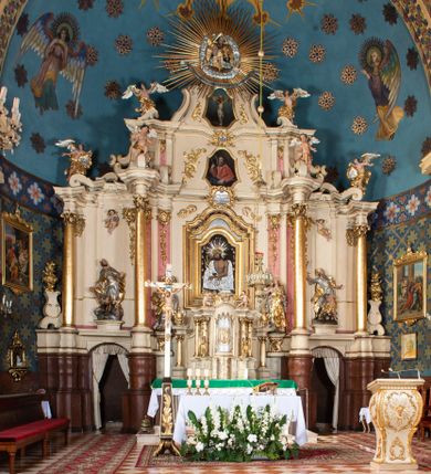 Zdjęcie nr 1: Nastawa ołtarzowa architektoniczna, dwukondygnacyjna, ze zwieńczeniem, pierwsza kondygnacja trójosiowa, druga jednoosiowa, ustawiona na dwustrefowym cokole z wyodrębnionymi, cylindrycznymi fragmentami, z bramkami na osiach bocznych. Ołtarz prostopadłościenny, murowany, z kamienną mensą i kamiennym portatylem. 
Pierwsza kondygnacja wydzielona czterema parami wklęsłych pilastrów o trzonach dekorowanych rocaille'em i zwisami kwiatowymi oraz stojącymi na ich tle dwiema parami kolumn o kapitelach kompozytowych. Podpory dźwigają niepełne belkowanie, przerwane nad polami kondygnacji, obniżone nad zewnętrzną parą kolumn. Na skrajnej partii cokołu nastawy karbowane woluty z fantazyjnymi gruszkowatymi cokołami podtrzymującymi rocaille'owe wazony. W polu środkowym głęboka wnęka w formie stojącego prostokąta zamkniętego łukiem odcinkowym podwójnie nadwieszonym z uskokiem, ujęta profilowaną ramą, z obrazem Ecce Homo w osobnej, podwójnej ramie. Nad nią kartusz rokokowy z napisem „In nomine Jesu / om(n)e Genu flec / tatur. ad Philipenses / Cap(ut) II”. Wnękę flankują figury Matki Boskiej i św. Marii Magdaleny ustawione na rocaille'owych konsolach. Na osiach bocznych figura Dawida i grupa ofiary Izaaka na cokołach z nadlatującymi puttami nad nimi. Druga kondygnacja flankowana trzema parami pilastrów o trzonach przechodzących w spływy wolutowe i osobne woluty, opadające na belkowanie pierwszej kondygnacji, na których siedzą putta i anioły trzymające kartusze z napisami: „ET / GLORIA” i „SOLI / DEO / HONOR”. Kondygnacja zamknięta profilowanym gzymsem wyłamanym na ich osi oraz załamanym w dół nad polem. Na gzymsie fragmenty przerwanego, falistego przyczółka, na których siedzą anioły. W polu obraz św. Macieja w formie zbliżonej do trapezu o dwóch wypukłych bokach, ujęty profilowaną ramą. Pole flankowane akantem, powyżej rocaille'owy kartusz z napisem: „IN / CRUCE / SALUS”. Zwieńczenie w formie zbliżonej do trapezu, o wklęsłych bokach, ujętych wolutami, zamknięte cęgowymi wolutami. W polu obraz Ukrzyżowania w formie zbliżonej do trapezu o dwóch wypukłych bokach, ujęty profilowaną ramą, flankowany akantem. Całość zamknięta płaskorzeźbionym przedstawieniem popiersia Boga Ojca oraz gołębicy Ducha Świętego w glorii, w otoku z obłoków i uskrzydlonych główek anielskich, w glorii promienistej, u dołu szarfa z napisem: „Hic est Filius meus dilectus in quo mihi bene complacui ipsum audite. Luc[a] XVII”. Struktura polichromowana w kolorze beżowym, dolna strefa cokołu brązowa, część trzonów pilastrów pomalowana na kolor jasnoróżowy; trzony kolumn, profile i ornamentyka złocone, detal srebrzony.  


