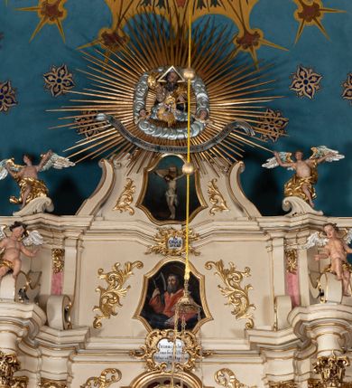 Zdjęcie nr 46: Nastawa ołtarzowa architektoniczna, dwukondygnacyjna, ze zwieńczeniem, pierwsza kondygnacja trójosiowa, druga jednoosiowa, ustawiona na dwustrefowym cokole z wyodrębnionymi, cylindrycznymi fragmentami, z bramkami na osiach bocznych. Ołtarz prostopadłościenny, murowany, z kamienną mensą i kamiennym portatylem. 
Pierwsza kondygnacja wydzielona czterema parami wklęsłych pilastrów o trzonach dekorowanych rocaille'em i zwisami kwiatowymi oraz stojącymi na ich tle dwiema parami kolumn o kapitelach kompozytowych. Podpory dźwigają niepełne belkowanie, przerwane nad polami kondygnacji, obniżone nad zewnętrzną parą kolumn. Na skrajnej partii cokołu nastawy karbowane woluty z fantazyjnymi gruszkowatymi cokołami podtrzymującymi rocaille'owe wazony. W polu środkowym głęboka wnęka w formie stojącego prostokąta zamkniętego łukiem odcinkowym podwójnie nadwieszonym z uskokiem, ujęta profilowaną ramą, z obrazem Ecce Homo w osobnej, podwójnej ramie. Nad nią kartusz rokokowy z napisem „In nomine Jesu / om(n)e Genu flec / tatur. ad Philipenses / Cap(ut) II”. Wnękę flankują figury Matki Boskiej i św. Marii Magdaleny ustawione na rocaille'owych konsolach. Na osiach bocznych figura Dawida i grupa ofiary Izaaka na cokołach z nadlatującymi puttami nad nimi. Druga kondygnacja flankowana trzema parami pilastrów o trzonach przechodzących w spływy wolutowe i osobne woluty, opadające na belkowanie pierwszej kondygnacji, na których siedzą putta i anioły trzymające kartusze z napisami: „ET / GLORIA” i „SOLI / DEO / HONOR”. Kondygnacja zamknięta profilowanym gzymsem wyłamanym na ich osi oraz załamanym w dół nad polem. Na gzymsie fragmenty przerwanego, falistego przyczółka, na których siedzą anioły. W polu obraz św. Macieja w formie zbliżonej do trapezu o dwóch wypukłych bokach, ujęty profilowaną ramą. Pole flankowane akantem, powyżej rocaille'owy kartusz z napisem: „IN / CRUCE / SALUS”. Zwieńczenie w formie zbliżonej do trapezu, o wklęsłych bokach, ujętych wolutami, zamknięte cęgowymi wolutami. W polu obraz Ukrzyżowania w formie zbliżonej do trapezu o dwóch wypukłych bokach, ujęty profilowaną ramą, flankowany akantem. Całość zamknięta płaskorzeźbionym przedstawieniem popiersia Boga Ojca oraz gołębicy Ducha Świętego w glorii, w otoku z obłoków i uskrzydlonych główek anielskich, w glorii promienistej, u dołu szarfa z napisem: „Hic est Filius meus dilectus in quo mihi bene complacui ipsum audite. Luc[a] XVII”. Struktura polichromowana w kolorze beżowym, dolna strefa cokołu brązowa, część trzonów pilastrów pomalowana na kolor jasnoróżowy; trzony kolumn, profile i ornamentyka złocone, detal srebrzony.  


