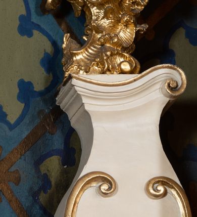Zdjęcie nr 54: Nastawa ołtarzowa architektoniczna, dwukondygnacyjna, ze zwieńczeniem, pierwsza kondygnacja trójosiowa, druga jednoosiowa, ustawiona na dwustrefowym cokole z wyodrębnionymi, cylindrycznymi fragmentami, z bramkami na osiach bocznych. Ołtarz prostopadłościenny, murowany, z kamienną mensą i kamiennym portatylem. 
Pierwsza kondygnacja wydzielona czterema parami wklęsłych pilastrów o trzonach dekorowanych rocaille'em i zwisami kwiatowymi oraz stojącymi na ich tle dwiema parami kolumn o kapitelach kompozytowych. Podpory dźwigają niepełne belkowanie, przerwane nad polami kondygnacji, obniżone nad zewnętrzną parą kolumn. Na skrajnej partii cokołu nastawy karbowane woluty z fantazyjnymi gruszkowatymi cokołami podtrzymującymi rocaille'owe wazony. W polu środkowym głęboka wnęka w formie stojącego prostokąta zamkniętego łukiem odcinkowym podwójnie nadwieszonym z uskokiem, ujęta profilowaną ramą, z obrazem Ecce Homo w osobnej, podwójnej ramie. Nad nią kartusz rokokowy z napisem „In nomine Jesu / om(n)e Genu flec / tatur. ad Philipenses / Cap(ut) II”. Wnękę flankują figury Matki Boskiej i św. Marii Magdaleny ustawione na rocaille'owych konsolach. Na osiach bocznych figura Dawida i grupa ofiary Izaaka na cokołach z nadlatującymi puttami nad nimi. Druga kondygnacja flankowana trzema parami pilastrów o trzonach przechodzących w spływy wolutowe i osobne woluty, opadające na belkowanie pierwszej kondygnacji, na których siedzą putta i anioły trzymające kartusze z napisami: „ET / GLORIA” i „SOLI / DEO / HONOR”. Kondygnacja zamknięta profilowanym gzymsem wyłamanym na ich osi oraz załamanym w dół nad polem. Na gzymsie fragmenty przerwanego, falistego przyczółka, na których siedzą anioły. W polu obraz św. Macieja w formie zbliżonej do trapezu o dwóch wypukłych bokach, ujęty profilowaną ramą. Pole flankowane akantem, powyżej rocaille'owy kartusz z napisem: „IN / CRUCE / SALUS”. Zwieńczenie w formie zbliżonej do trapezu, o wklęsłych bokach, ujętych wolutami, zamknięte cęgowymi wolutami. W polu obraz Ukrzyżowania w formie zbliżonej do trapezu o dwóch wypukłych bokach, ujęty profilowaną ramą, flankowany akantem. Całość zamknięta płaskorzeźbionym przedstawieniem popiersia Boga Ojca oraz gołębicy Ducha Świętego w glorii, w otoku z obłoków i uskrzydlonych główek anielskich, w glorii promienistej, u dołu szarfa z napisem: „Hic est Filius meus dilectus in quo mihi bene complacui ipsum audite. Luc[a] XVII”. Struktura polichromowana w kolorze beżowym, dolna strefa cokołu brązowa, część trzonów pilastrów pomalowana na kolor jasnoróżowy; trzony kolumn, profile i ornamentyka złocone, detal srebrzony.  


