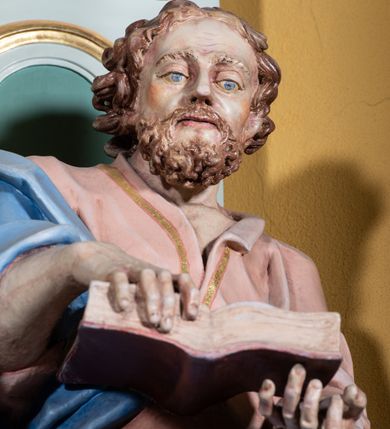 Zdjęcie nr 17: Ołtarz przyścienny, prostopadłościenny, z antepedium, na którym umieszczony jest rzeźbiony monogram Marii; mensa drewniana z kamiennym portatylem. Na mensie znajduje się tabernakulum o kształcie graniastosłupa, z drzwiczkami ozdobionymi rzeźbionym kielichem z hostią. Nastawa ołtarzowa jest architektoniczna, jednoosiowa, jednokondygnacyjna ze zwieńczeniem. Osadzona na podwójnym postumencie, flankowana pilastrami o kompozytowych kapitelach i kanelowanymi kolumnami o kompozytowych kapitelach, które podtrzymują belkowanie. Ponad belkowaniem znajduje się przełamany przyczółek w formie łuku półkolistego, bogato profilowany, ozdobiony ulistnionymi konsolkami i rozetami oraz girlandami z owoców. W partii fryzu kartusz o fantazyjnym wykroju, ujęty wolutami i listkami akantu. Na belkowaniu siedzą po bokach putta, odziane tkaniną na biodrach, a pośrodku znajduje się krzyż osadzony na postumencie z liśćmi. Po obu stronach ołtarza na konsolach o krawędziach ozdobionych ornamentem małżowinowym stoją figury trudnych do identyfikacji świętych, być może apostołów. W centralnej części ołtarza wnęka prostokątna, zamknięta łukiem półkolistym, wypełniona złoconą blachą z rytą ukośną kratką wypełnioną rozetkami. Na blasze zawieszony obraz z przedstawieniem Matki Boskiej Nieustającej Pomocy, który ujęty jest w prostokątną, blaszaną ramę. 

