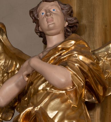 Zdjęcie nr 21: Dwukondygnacyjny, jednoosiowy ołtarz ze zwieńczeniem uzyskał strukturę architektoniczną. Stipes ołtarzowy wykonano w formie granitowego prostopadłościanu z mensą. Na mensie na osi ołtarza ustawiono tabernakulum z tronem wystawienia. Tabernakulum otrzymało kształt drewnianej skrzynki obitej blachą z drzwiczkami w formie stojącego prostokąta, z sześcioma kwaterami przedstawiającymi sceny z Pisma Świętego. Całość zamknięto silnie wysuniętym gzymsem wypukłym od frontu. Tron wystawienia utworzono w formie baldachimu ozdobionego lambrekinem z chwostami. Ujmują go spływy wolutowe z podwieszoną tkaniną, dekorowane liśćmi akantu. W przestrzeni zaplecka tronu umieszczono w promienistej glorii medalion z chrystogramem "IHS". Nastawa została ustawiona na wysokim cokole, zwieńczonym profilowanym gzymsem z wyodrębnionymi dwoma wspornikami skierowanymi do wewnątrz. Retabulum ujmuje  zwrócona na zewnątrz opilastrowana para filarów, przed którymi stoi para kolumn o kapitelach kompozytowych dźwigających pełne belkowanie wyłamane na ich osi. W polu centralnym znajduje się nisza w kształcie stojącego prostokąta zwieńczonego przerwanym prostokątnie łukiem półkolistym, nadwieszonym. Niszę obramienia profilowana rama. W jej wnętrzu znajduje się obraz Wniebowzięcia Najświętsze Marii Panny w drewnianych sukienkach wotywnych. Druga kondygnacja ujęta została dwiema parami zwróconych na zewnątrz pilastrów o trzonach przechodzących w spływy wolutowe. Pilastry dźwigają gzyms wyłamany na ich osi, który w części centralnej przyjmuje kształt spłaszczonego łuku. W polu umieszczono obraz z przedstawieniem Michała Archanioła w formie stojącego prostokąta o wklęsłych, dłuższych krawędziach oraz krótszych o kształcie łuku półkolistego nadwieszonego. Nastawa zakończona została okiem Opatrzności Bożej w glorii promienistej. Na cokole przed podporami ustawiono cztery figury adorujących aniołów. Ramę w polu środkowym udekorowano ornamentem roślinnym. W górnych przyłuczach umieszczono figury puttów na obłokach. Fryz został ozdobiony kwiatowymi girlandami. Centralnie na osi na gzymsie zawieszono kartusz z monogramem Marii w polu. Na zewnętrznych krawędziach belkowania pierwszej kondygnacji siedzą dwie figury aniołów, a na spływach wolutowych cztery putta. W trzonach pilastrów drugiej kondygnacji widoczne są zwisy z ornamentem kwiatowym podwieszonym na wstążce. W polu centralnym na dole umieszczono dwa wieńce, a u góry dwie uskrzydlone główki anielskie. Na belkowaniu znajdują się dwa putta na obłokach. Struktura nastawy została polichromowana w kolorze kości słoniowej, natomiast kolumny, pilastry, profile i ornamentyka zostały wyzłocone, a obłoki posrebrzone.