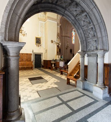 Zdjęcie nr 37: Kościół Wniebowzięcia Najświętszej Marii Panny w Oświęcimu jest świątynia murowaną, orientowaną. Dwuprzęsłowe prezbiterium zamknięte ścianą prostą wzniesiono na rzucie prostokąta. W jego narożach widoczne są przypory. Od południa wybudowano przy nim zakrystię, a od północy kaplicę Chrystusa Ukrzyżowanego, którą gruntownie przebudowano w stylu pseudoromańskim w latach dwudziestych XX wieku. Korpus kościoła uzyskał układ trójnawowej, dwuprzęsłowej hali. Od zachodu na osi wzniesiono czworoboczną, dwupoziomową wieżę. Pierwszy poziom, w którym urządzono kruchtę, jest zaopatrzony w narożach w uskokowe przypory. Natomiast drugi, wyraźnie zmniejszony, został wzniesiony ponad profilowanym gzymsem na rzucie czworobocznym o ściętych narożach. Całość nakryto ostrosłupowym hełmem zwieńczonym krzyżem, wspartym na trójkątnych przyczółkach stanowiących zakończenie ścian drugiego poziomu. Nawa główna otwiera się do naw bocznych z każdej strony poprzez dwiema opilastrowanymi arkadami filarowymi. Tęcza pomiędzy nawą, a prezbiterium uzyskała wykrój półkolisty. Wnetrze obu części kościoła nakryto sklepieniem kolebkowym z lunetami wsparte na gurtach. W części zachodniej kościoła na długości całego korpusu urządzono chór muzyczny wsparty na trzech arkadach z parapetem wygiętym łukowo pośrodku. Sklepienie i parapet chóru zostały udekorowane figurami geometrycznymi ze stiukowych listw profilowanych. Do południowej nawy bocznej prowadzi gotycki, ostrołukowy portal kamienny. Z kolei wejście do prezbiterium z zakrystii oraz z kruchty do północnej nawy bocznej obramieniają dwa prostokątne, kamienne portale gotycko-renesansowe. W prezbiterium ustawiono ołtarz główny, a dwa ołtarze boczne na wschodniej ścianie naw bocznych. Kolejny ołtarz boczny znalazł się po prawej stronie łuku tęczowego. Po jego zaś drugiej stronie zawieszono ambonę. 