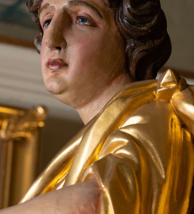 Zdjęcie nr 21: Nastawa architektoniczna, trójosiowa, dwukondygnacyjna, ustawiona na wysokim cokole z wyodrębnionymi prostopadłościanami. Ołtarz prostopadłościenny, z drewnianą mensą. Antepedium ujęte profilowaną ramą, w polu medalion z monogramem IHS w glorii. Na ołtarzu ustawione tabernakulum z tronem wystawienia. Tabernakulum w formie trójosiowej skrzynki, o wklęsło-wypukłym licu, artykułowanej kolumienkami o kręconych trzonach, podtrzymującymi belkowanie, wyłamane na ich osi, z gzymsem wyłamanym faliście na osi środkowej. Drzwiczki w formie stojącego prostokąta zamkniętego łukiem półkolistym nadwieszonym z uskokiem, ujętego ramą z płaskorzeźbionym przedstawieniem kielicha z hostią w glorii. Na osiach bocznych płaskorzeźbione przedstawienia winnego grona. Tron wystawienia w formie paludamentu, podwójnie podwieszonego po bokach, zwieńczonego koroną zamkniętą. 
Cokół dekorowany płycinami wypełnionymi suchym akantem. Pierwsza kondygnacja nastawy ujęta dwiema parami kolumn o kapitelach kompozytowych oraz stojącą między nimi parą pilastrów, w których trzonach znajdują się gabloty na wota. Przed pilastrami na cokołach ustawione dwie figury aniołów. Podpory dźwigają pełne belkowanie, przerwane w partii architrawu i fryzu nad polem środkowym, wyłamane na osi kolumn, na osi pilastrów belkowanie wyłamane pod kątem, w formie impostu z podwieszonymi szyszkami. Na belkowaniu, na obłokach dwie figurki adorujących puttów oraz dwa wazony na cokołach. W polu środkowym wnęka w formie stojącego prostokąta o wciętych górnych narożach, ujęta podwójną ramą, dekorowaną ornamentem roślinnym, z obrazem św. Józefa. Wnęka otoczona z trzech stron gablotami z wotami. Nad nią, w polu belkowania kartusz utworzony z suchego akantu z napisem w polu: „ŚW(IĘTY) JÓZEFIE / MÓDL SIĘ / ZA NAMI”. Druga kondygnacja o szerokości osi środkowej, ustawiona na cokole z wyodrębnionymi prostopadłościanami oraz gablotą z wotami, ujęta dwiema parami pilastrów i spływami wolutowymi oraz stojącą przed nimi parą kolumn, dźwigających zdwojone imposty oraz fragmenty przerwanego, półkolistego przyczółka z siedzącymi puttami. Spływy zdobione festonami utworzonymi z wstęgi oraz kwiatów. Całość zamknięta fragmentem falistego gzymsu oraz Okiem Opatrzności w glorii promienistej. W polu obraz Zaślubin Marii ze św. Józefem w formie stojącego prostokąta o ściętych narożach, ujęty ramą dekorowaną ornamentem roślinnym. Flankowany dwiema prostokątnymi płycinami wypełnionymi akantem. Obie kondygnacje ujęte uszami utworzonymi z suchego akantu. Struktura polichromowana w kolorze zielonym, kolumny, ornamentyka i profile złocone.




