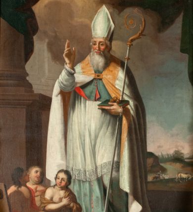 Zdjęcie nr 1: Obraz w kształcie stojącego prostokąta ukazuje św. Mikołaja w całej postaci, frontalnie. Jego twarz jest okolona siwą, długą brodą, nos prosty, oczy szeroko otwarte. Biskup jest ubrany w jasnobłękitną albę, komżę, mucet i biały płaszcz płaszcz ze złotymi brzegami spięty pod szyją, z infułą na głowie. Święty prawą rękę unosi w geście błogosławieństwa, w lewej przytrzymuje księgę z trzema złotymi kulami i pastorał. Na ziemi, po prawej stronie świętego, trzej młodzieńcy w drewnianym szafliku, przepasani brązowymi i czerwonymi tkaninami. Za świętym fragment kolumny z kotarą oraz krajobraz z końmi przy rzece. Niebo błękitne z szaro-brązowymi chmurami. 
