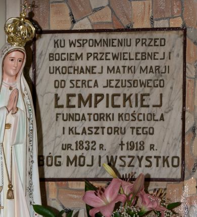 Zdjęcie nr 1: Kamienna tablica pamiątkowa w kształcie zbliżonym do kwadratu, ujęta wąskim, malowanym w kolorze ciemnego brązu obramieniem zawiera złoconą inskrypcję: „KU WSPOMNIENIU PRZED / BOGIEM PRZEWIELEBNEJ I / UKOCHANEJ MATKI MARJI / OD SERCA JEZUSOWEGO 
 ŁEMPICKIEJ / FUNDATORKI KOŚCIOŁA / I KLASZTORU TEGO / 
 UR(ODZONEJ) 1832 R(OKU) + 1918 R(OKU) / BÓG MÓJ I WSZYSTKO

