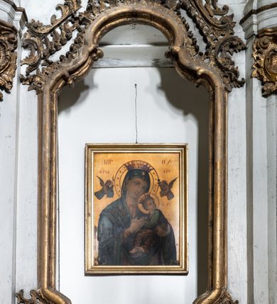 Zdjęcie nr 7: Przyścienny ołtarz Matki Boskiej Częstochowskiej uzyskał formę architektonicznej nastawy jednokondygnacyjnej, jednoosiowej ze zwieńczeniem. Drewniana mensa z portatylem flankowana przez dwustrefowy wklęsło-wypukły cokół wspiera się na ażurowym, konsolowym stipesie ołtarzowym, dekorowanym ornamentami rocalliowymi. Kondygnacja wsparta na dwustrefowym cokole została ujęta dwiema parami pilastrów zwróconych delikatnie do wewnątrz oraz silnie wysuniętą do przodu parą kolumn o kapitelach kompozytowych. Podpory dźwigają belkowanie o wklęsło-wypukłej linii. Nad polem środkowym belkowanie jest przerwane, a na osiach podpór wyłamane. Na przedłużeniu kolumn na belkowaniu usytuowano wolutowe przyczółki dekorowane rocalliem, stanowiących postumenty do skradzionych figur aniołów. W polu środkowym umieszczono obecnie obraz Matki Boskiej Nieustającej Pomocy Najświętszego, ujęty profilowaną, złoconą ramą w formie stojącego prostokąta zamkniętego łukiem półkolistym nadwieszonym z uskokiem, dekorowaną ornamentem rocalliowym. Poniżej obrazu pomiędzy dwiema rocalliowymi konsolami widnieje zdjęcie obrazu św. Jana Nepomucena. Zwieńczenie uzyskało formę leżącego prostokąta o wklęsłych, wolutowych bokach przechodzących u góry we wklęsło-wypukłe belkowanie, przyjmujące nad polem formę łuku falistego. W polu zwieńczenia znalazło się zdjęcie obrazu ze św. Józefem ujęte we wklęsło-wypukłą, profilowaną i złoconą ramę. Pilastry kondygnacji ozdobiono kapitelami z rocaille, a ich trzony udekorowano złoconymi zwisami utworzonymi z rocaille, rozet i liści. Całość struktury polichromowano na biało, a ornamenty i profile zostały wyzłocone. 