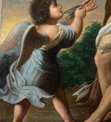 Zdjęcie nr 3: Obraz w formie stojącego prostokąta w drewnianej, profilowanej ramie. W centrum św. Sebastian przywiązany do drzewa, zwrócony w trzech czwartych w prawo, silnie pochylony, z rękami związanymi na plecach, z wysuniętą lewą nogą. Twarz ma wyrazistą, nos długi, usta lekko otwarte, oczy zamknięte, a włosy czarne. Jego nagie ciało przepasane na biodrach jest przebite czterema strzałami. Przed nim stoi anioł, który wyciąga z jego piersi strzałę. Anioł ma twarz pełną, nos krótki, usta drobne, włosy gęste, ciemne, z drobnymi puklami. Ubrany jest w luźną, niebieską suknię, odkrywającą dłonie i plecy oraz nogi. U stóp świętego leży tarcza, kołczan ze strzałami i łuk. W tle widoczne drzewa i krzewy oraz niebo. 