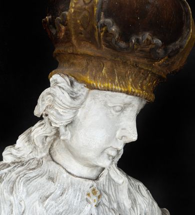 Zdjęcie nr 4: Rzeźba przedstawia całopostaciowe wyobrażenie św. Kazimierza Królewicza. Święty został ukazany w mocnym kontrapoście w trzech czwartych w prawo. Obie uniesione ręce ma odsunięte od tułowia. Kazimierz został ukazany jako młodzieniec o pociągłej twarzy z wydatnym nosem i ustami. Jego głowę otaczają długie, falujące włosy opadające na plecy. Na głowie ma zamkniętą, złoconą koronę z globem i krzyżykiem. Ubrany jest w przewiązaną tunikę i rozwiany, mocno drapowany płaszcz z gronostajowym kołnierzem. Spod tuniki widać nogi obute w złocone trzewiki. Rzeźba w całości polichromowana na biało, ze złoconymi dodatkami.  