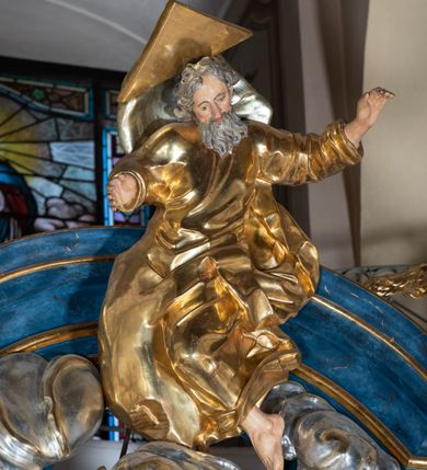 Zdjęcie nr 18: Ołtarz architektoniczny, jednoosiowy, jednokondygnacyjny ze zwieńczeniem. Na zdwojonych cokołach usytuowanych ukośnie względem osi po trzy kompozytowe kolumny opinające filary o gładkich trzonach podtrzymujących wyłamujące się nad nimi belkowanie z ćwierćkolistymi naczółkami. Na nich siedzące anioły z narzędzami męki Pańskiej. Pośrodku wnęka zamknięta półkoliście i wchodząca w partię belkowania z figurą Ukrzyżowanego. Nad wnęką dwa nagie putta trzymają kartusz z napisem: &quot;DZIEŁO / NIE MAJĄC PRZYKŁADU / ŁASKA NIE ZASŁUŻONA / DAR NIE OCENIONY / MIŁOŚĆ BEZ GRANIC&quot;.  Zwieńczenie ujęte spływami wolutowymi, mocno zwężające się ku górze, zakończone gzymsem w formie łuku nadwieszonego. W polu owalny prześwit z glorią promienistą w chmurach z figurą Boga Ojca, puttami siedzącymi na gzymsie i główkami aniołów wśród chmur. Po bokach ołtarza dwie bramki z cokołami ujętymi spływami wolutowymi, na których figury św. Jana Chrzciciela i św. Jana Ewangelisty. Dekoracja ornamentalna w postaci rozłożystych liści na cokołach oraz liściastych, ażurowych uszy ujmujących nastawę. 